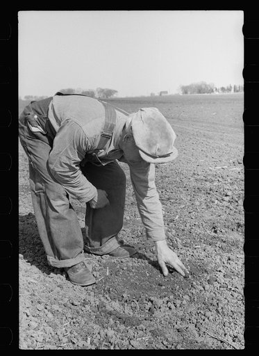 Untitled photo, possibly related to: County agent and farmer examining amount of gas in tank, Grundy County, Iowa