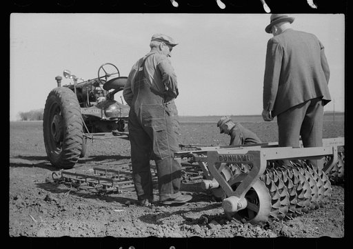 Untitled photo, possibly related to: County agent and farmer examining amount of gas in tank, Grundy County, Iowa