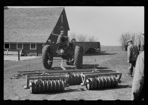 Untitled photo, possibly related to: County agent and farmer examining amount of gas in tank, Grundy County, Iowa