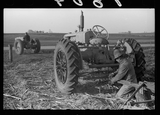 Untitled photo, possibly related to: Detaching disc from tractor at end of day's work, Grundy County, Iowa