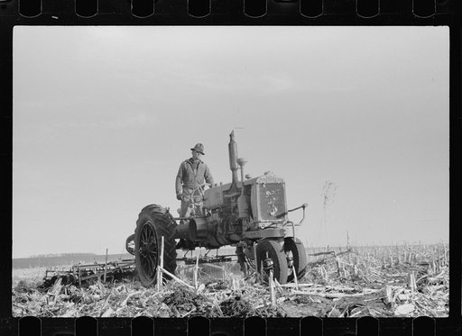 Untitled photo, possibly related to: Detaching disc from tractor at end of day's work, Grundy County, Iowa