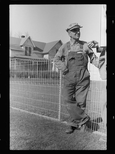 Untitled photo, possibly related to: County agent and farmer looking at electric meter on farm, Grundy County, Iowa