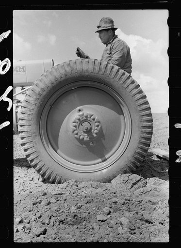 Farm boy operating tractor, Grundy County, Iowa