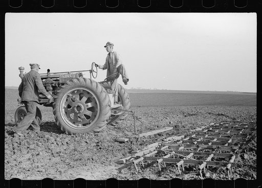 Untitled photo, possibly related to: Adjusting wire in stake. Corn planting, Jasper County, Iowa