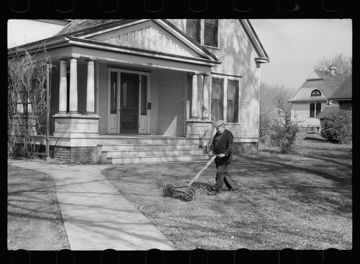 Man mowing lawn, Grundy Center, Iowa