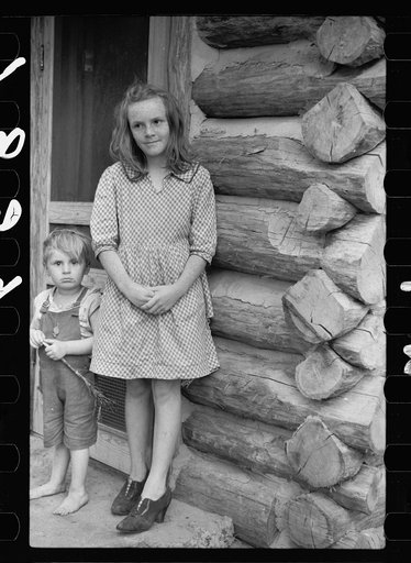 Children living in log cabin of Missouri, Ozark country