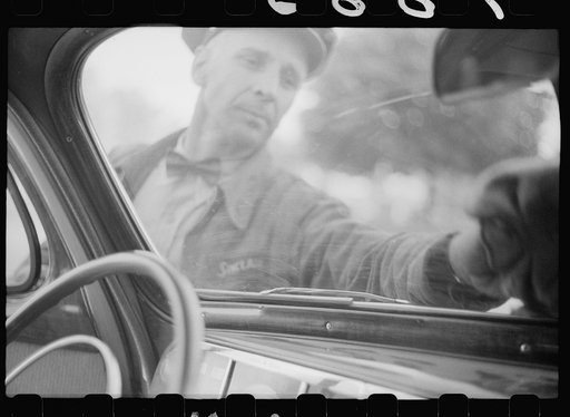Wiping off windshield in service station, Cairo, Illinois