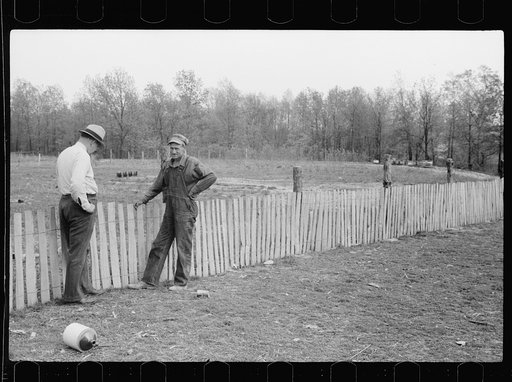 County supervisor visiting FSA (Farm Security Administration) borrower who is building a picket fence around his place, Grant County, Illinois
