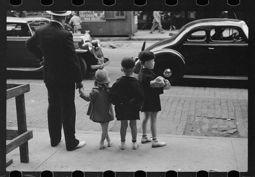 Father and three children waiting to cross the street, Chicago, Illinois