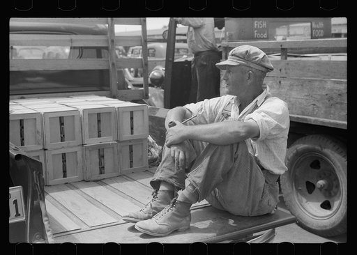 Untitled photo, possibly related to: Buyer examining cherries in fruit market, Benton Harbor, Michigan