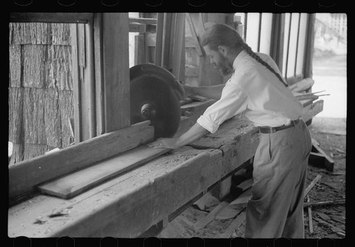 Member of House of David using circular saw, Benton Harbor, Michigan