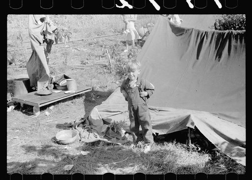 Untitled photo, possibly related to: Migrant child eating in front of tent home, Berrien County, Michigan