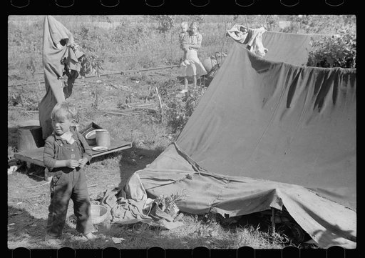 Untitled photo, possibly related to: Migrant child eating in front of tent home, Berrien County, Michigan