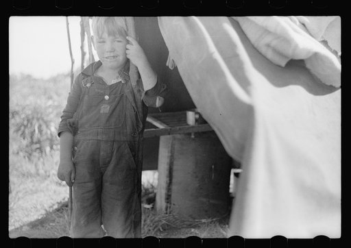 Untitled photo, possibly related to: Migrant child eating in front of tent home, Berrien County, Michigan
