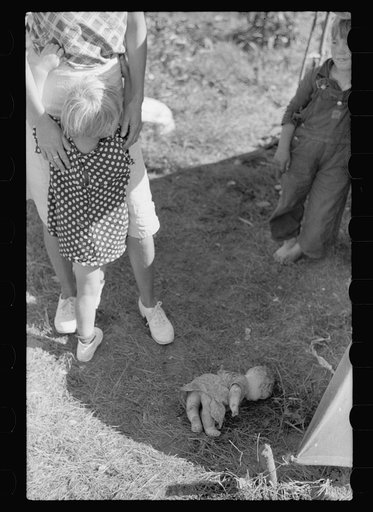 Untitled photo, possibly related to: Migrant child eating in front of tent home, Berrien County, Michigan