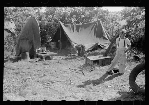 Untitled photo, possibly related to: Migrant child eating in front of tent home, Berrien County, Michigan