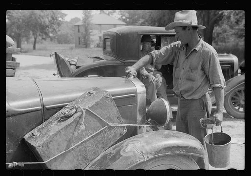 Migrant fruit worker getting his car ready to move on in search of work, Berrien County, Michigan.