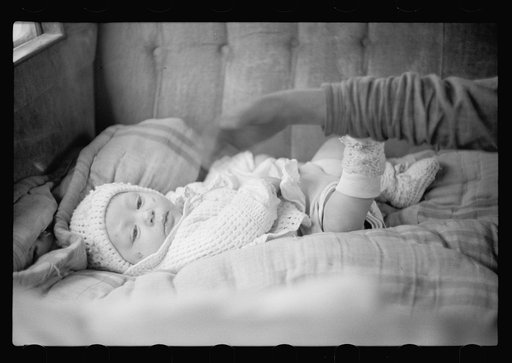 Untitled photo, possibly related to: Baby in back seat of migrant workers' automobile, Berrien County, Michigan