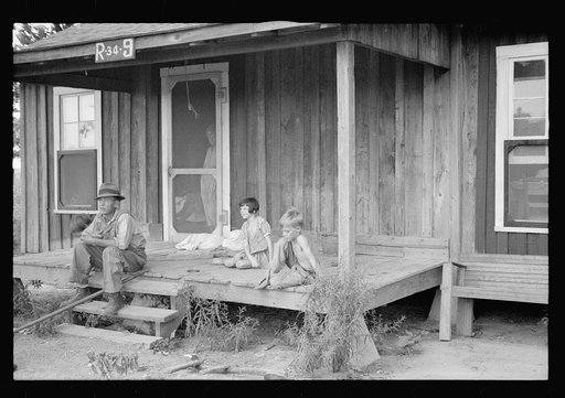 Sharecropper and children in front of company house. Wilson cotton plantation, Mississippi County, Arkansas