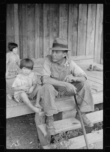 Untitled photo, possibly related to: Sharecropper and children in front of company house. Wilson cotton plantation, Mississippi County, Arkansas