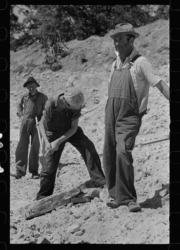 Untitled photo, possibly related to: Farmers who have been resettled at Skyline Farms, at work in sand pit