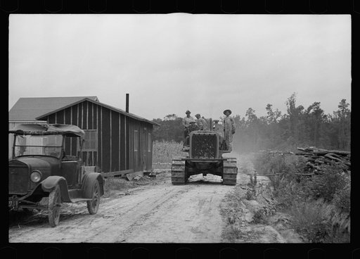 Untitled photo, possibly related to: Tractor being used to clear land, Pender County, North Carolina