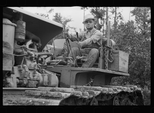 Untitled photo, possibly related to: Tractor being used to clear land, Pender County, North Carolina