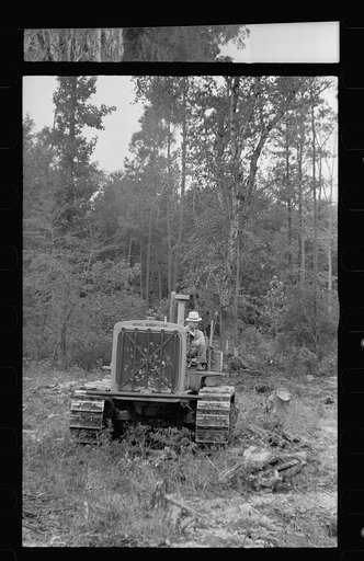 Untitled photo, possibly related to: Tractor being used to clear land, Pender County, North Carolina