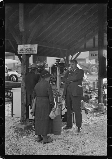 Salesman explaining new milking machine, State Fair, Rutland, Vermont