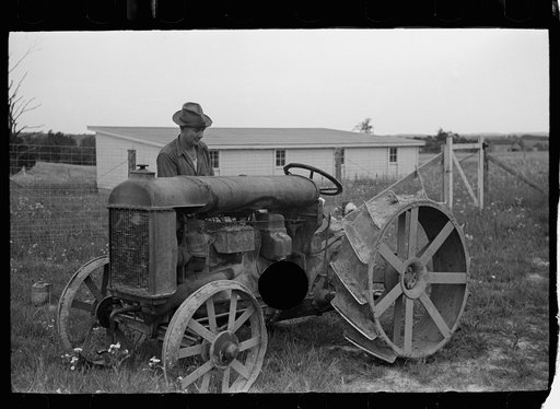 Untitled photo, possibly related to: Farmer on Loogootee unit oiling tractor, Wabash Farms, Indiana