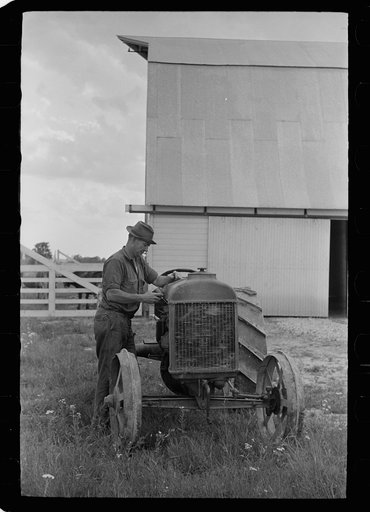 Farmer on Loogootee unit oiling tractor, Wabash Farms, Indiana