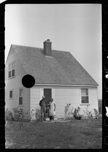 Untitled photo, possibly related to: Resettled farmer on steps of new home, Wabash Farms, Indiana