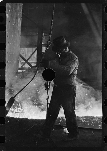 Untitled photo, possibly related to: Pouring a test mold while blast furnace is being tapped, Pittsburgh, Pennsylvania