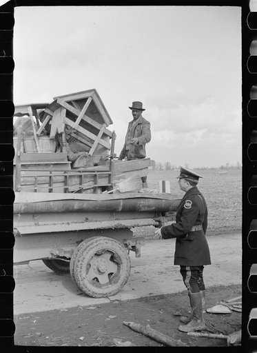State highway officials moving sharecroppers away from roadside to area between the levee and the Mississippi River, New Madrid County, Missouri