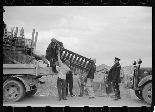 State highway officials moving evicted sharecroppers away from roadside to area between the levee and the Mississippi River, New Madrid County, Missouri
