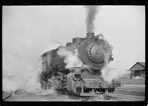 Untitled photo, possibly related to: Locomotive in railroad yards along river, St. Louis, Missouri