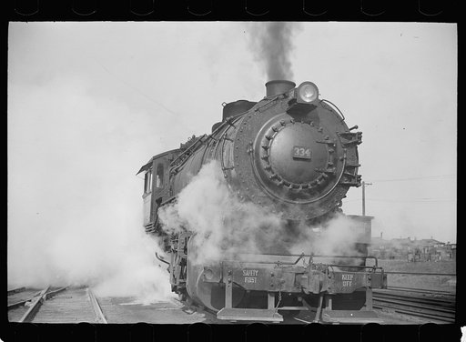 Untitled photo, possibly related to: Locomotive in railroad yards along river, St. Louis, Missouri