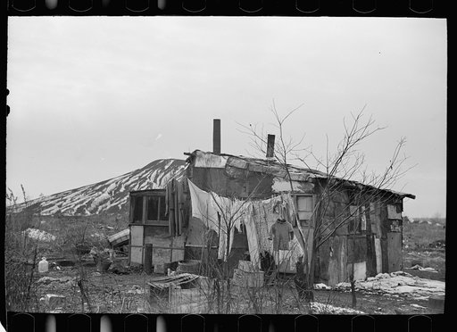 A shanty built of refuse near the Sunnyside slack pile, Herrin, Illinois Many residences in southern Illinois coal towns were built with money borrowed from building and loan associations. During the depression building and loan associations almost all went into receivership. Their mortgages were so