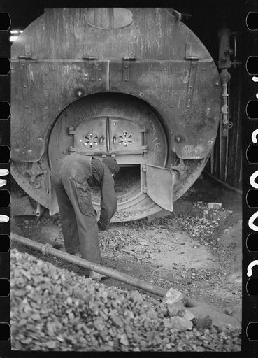Untitled photo, possibly related to: Stoking furnace at gopher hole, Williamson County, Illinois
