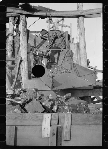 Untitled photo, possibly related to: Loading a truck with run of the mine coal at gopher hole, Williamson County, Illinois