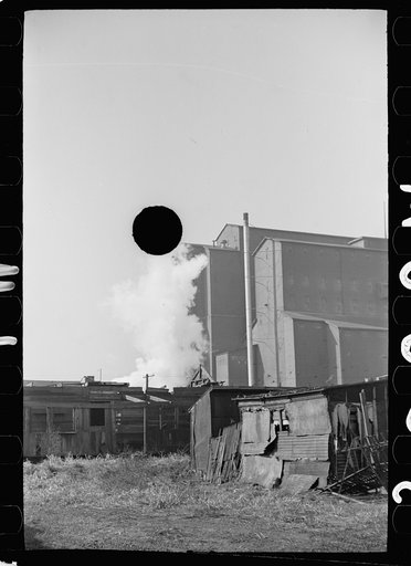 Untitled photo, possibly related to: Squatters' shacks with grain elevator in background, Saint Louis, Missouri