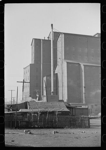 Untitled photo, possibly related to: Squatters' shacks with grain elevator in background, Saint Louis, Missouri