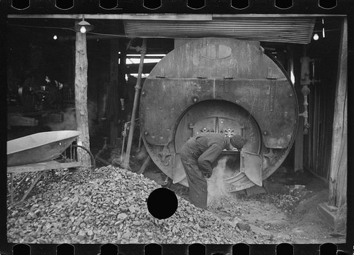 Untitled photo, possibly related to: Stoking furnace at gopher hole, Williamson County, Illinois