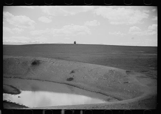 Sheep wagon at stock water reservoir, Madison County, Montana