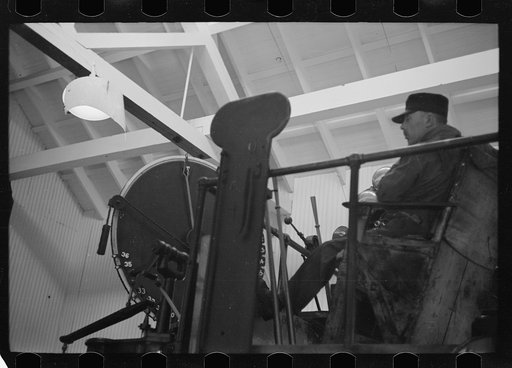 Untitled photo, possibly related to: Engineer at controls of high-speed hoist which reaches depth of 3800 feet. Copper mine, Butte, Montana