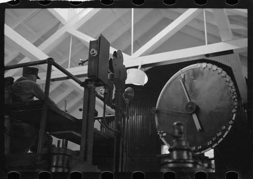 Engineer at controls of high-speed hoist which reaches depth of 3800 feet. Copper mine, Butte, Montana