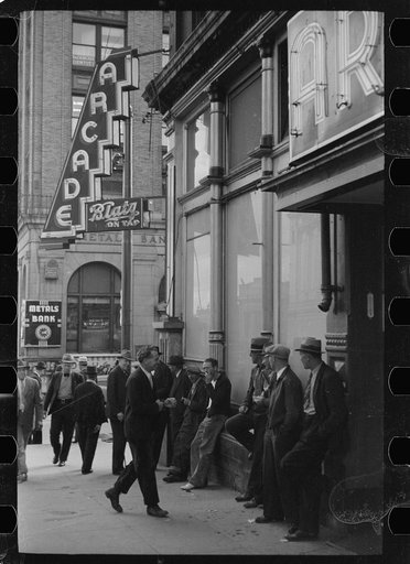 Men lounging in front of the arcade, Butte, Montana