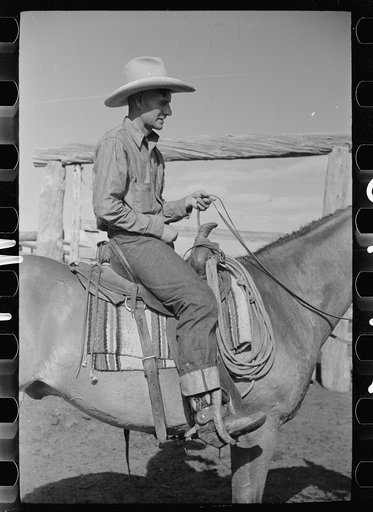 Untitled photo, possibly related to: Cowboy mounting horse, Quarter Circle U Ranch, Big Horn County, Montana