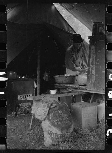 Untitled photo, possibly related to: Cowboy eating in Three Circle roundup camp, Powder River County, Montana