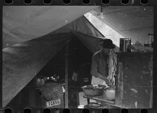 Untitled photo, possibly related to: Cowboy eating in Three Circle roundup camp, Powder River County, Montana